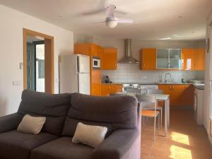 a living room with a couch and a kitchen at Apartamento en Na Macaret A in Na Macaret