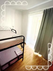 a bedroom with a bed and a window at La Merced Centro Rooms in Málaga