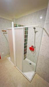 a shower with a glass door in a bathroom at La Merced Centro Rooms in Málaga