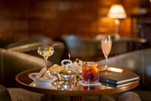 una mesa con dos copas de vino y un libro en Hotel Villa Cipriani, en Asolo