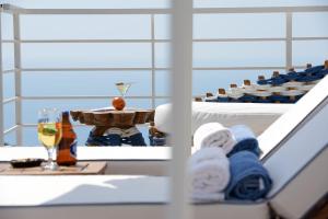a table with a glass of wine and towels at Highclere Hotel and Spa in Faralya