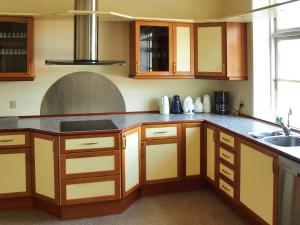 a kitchen with wooden cabinets and a sink at Apartment Thia - 4km to the inlet in SE Jutland by Interhome in Aabenraa