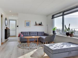 a living room with a couch and a table at Holiday Home Karli - 330m to the inlet in SE Jutland by Interhome in Aabenraa