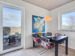 a dining room with a table and a window at Holiday Home Ewelina - 15km from the sea in Western Jutland by Interhome in Ballum