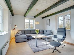 sala de estar con sofá, mesa y sillas en Holiday Home Nita - 24km from the sea in Western Jutland by Interhome en Højer