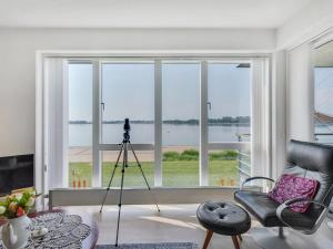 a room with a camera on a tripod in front of a window at Apartment Maja - 100m from the sea by Interhome in Gråsten