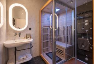 a bathroom with a shower and a sink at Le Palais Gallien Hôtel & Spa in Bordeaux
