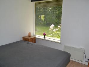 a bedroom with a bed and a large window at Holiday Home Florinka - 31km from the sea in Western Jutland by Interhome in Toftlund