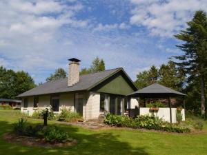 a small white house with a chimney and a gazebo at Holiday Home Florinka - 31km from the sea in Western Jutland by Interhome in Toftlund