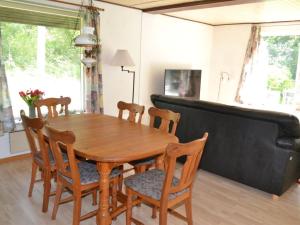 a dining room with a wooden table and chairs at Holiday Home Florinka - 31km from the sea in Western Jutland by Interhome in Toftlund