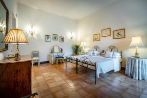 Postel nebo postele na pokoji v ubytování Palazzo Belmonte