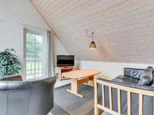 een woonkamer met een tafel en een bank bij Holiday Home Joris - 100m to the inlet in SE Jutland by Interhome in Gråsten