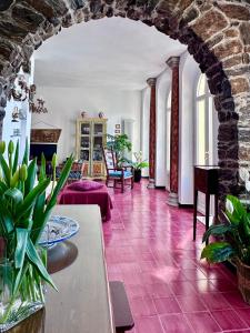 a living room with a red tile floor at Il Conventino delle Cinque Terre - Sea View - AC&WiFi - Vernazzarentals in Vernazza