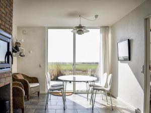 a dining room with a table and chairs and a window at Apartment Dilruba - 2-4km from the sea in Western Jutland by Interhome in Havneby