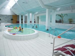 a group of people in a swimming pool at Apartment Dilruba - 2-4km from the sea in Western Jutland by Interhome in Havneby