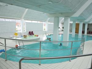 a large indoor swimming pool with people in it at Apartment Dilruba - 2-4km from the sea in Western Jutland by Interhome in Havneby