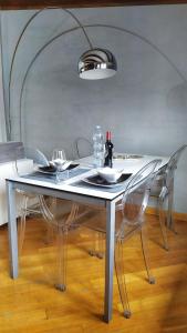 una mesa blanca con 2 sillas y una botella de vino en NOLO93 en Milán