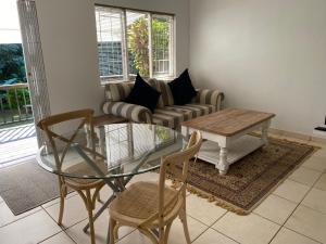 a living room with a glass table and a couch at Hillcrest Haven Haven Cottage 2 in Hillcrest