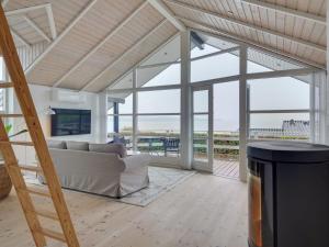 ein Wohnzimmer mit einem Sofa und Meerblick in der Unterkunft Holiday Home Nica - 100m from the sea in SE Jutland by Interhome in Broager