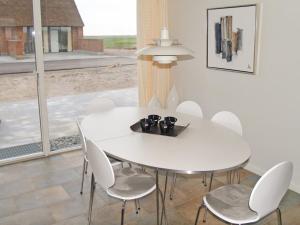 biała jadalnia z białym stołem i krzesłami w obiekcie Holiday Home Sophy - 2km from the sea in Western Jutland by Interhome w mieście Havneby