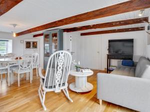 a living room with a couch and a table and chairs at Holiday Home Miko - 19km from the sea in Western Jutland by Interhome in Skærbæk