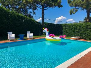 a pool with a unicorn float in a swimming pool at VILLA AGA in Noli