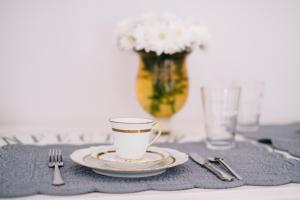 a cup of coffee on a plate on a table at VILLA AGA in Noli