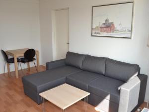 a living room with a couch and a table at Apartment Baltser - 5km from the sea in Western Jutland by Interhome in Kongsmark