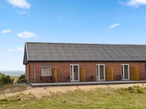 a red brick house on top of a hill at Apartment Baltser - 5km from the sea in Western Jutland by Interhome in Kongsmark
