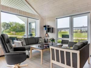 a living room with a couch and a table at Holiday Home Damiana - 500m from the sea by Interhome in Sarup
