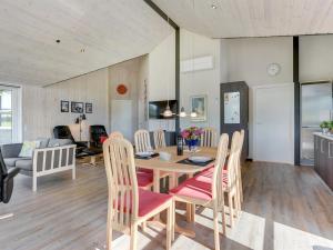 a dining room and living room with a table and chairs at Holiday Home Damiana - 500m from the sea by Interhome in Sarup +28 photos