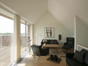 a living room with a couch and a table at Apartment Aapeli - 2km from the sea in Western Jutland by Interhome in Sønderby