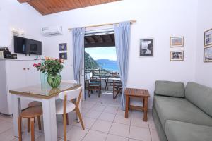 a living room with a couch and a table at Suzanne's Apartment Glyfada Menigos Resort in Glyfada