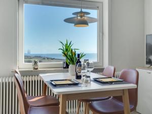 a dining room with a table and chairs and a window at Apartment Herkko - 25m from the sea in Western Jutland by Interhome in Esbjerg