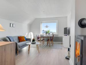 a living room with a couch and a table at Apartment Herkko - 25m from the sea in Western Jutland by Interhome in Esbjerg