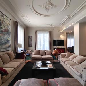 a living room with couches and a coffee table at Ada Home in Rome