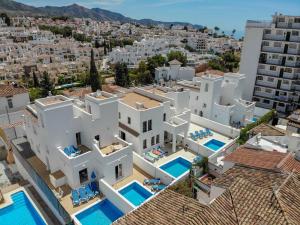 an aerial view of a white villa with swimming pools at Nerja Paradise Rentals - Villa Ambar in Nerja