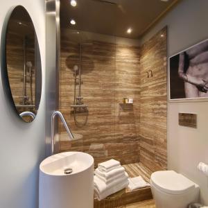 a bathroom with a shower and a toilet and a sink at Ada Home in Rome