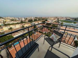 een balkon met 2 stoelen en uitzicht op de stad bij Nerja Paradise Rentals - Morasol Apt 7 in Nerja