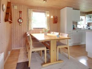 cocina con mesa de madera y sillas en una habitación en Holiday Home Pyry - 400m to the inlet in Western Jutland by Interhome en Skjern