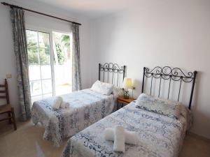 Postel nebo postele na pokoji v ubytování Nerja Paradise Rentals - Villa Las Palomas
