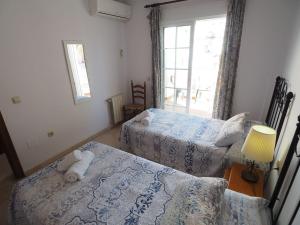 Postel nebo postele na pokoji v ubytování Nerja Paradise Rentals - Villa Las Palomas