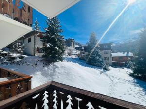a view from a balcony with snow on the ground at Lovely Apt Chalet Courchevel 1650 in Courchevel