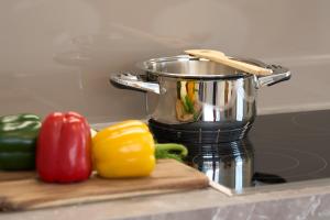 a food processor sitting on a cutting board with peppers at Ciasa Plandros Apartments in La Valle