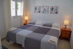 sypialnia z łóżkiem, 2 lampami i oknem w obiekcie Nerja Paradise Rentals - Villa Suero w mieście Nerja