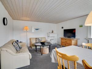 een woonkamer met een bank en een tafel bij Holiday Home Fransiska - from the sea in Western Jutland by Interhome in Ulfborg