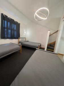 a large room with two beds and a staircase at Bushmills Youth Hostel in Bushmills