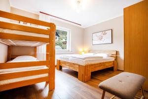 a bedroom with two bunk beds and a chair at House Stepic 