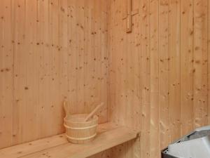 a wooden sauna with a basket on a shelf at Holiday Home Freding - 250m to the inlet by Interhome in Børkop