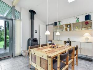 a kitchen with a wooden table and a stove at Holiday Home Freding - 250m to the inlet in SE Jutland by Interhome in Børkop